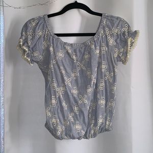Light blue crop top with cream pattern. Size: M